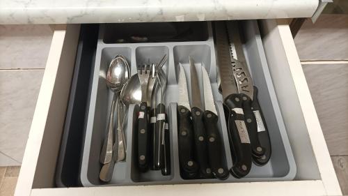 a drawer filled with utensils in a cabinet at sobe MAŠA in Subotica