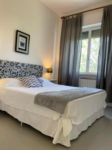 a bedroom with a large bed and a window at Villa Simonetta in Castellina Marittima
