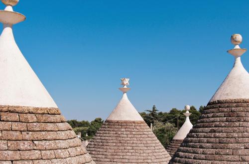 a group of pointed roofs with a bird on top at Relais I Secolari in Selva di Fasano