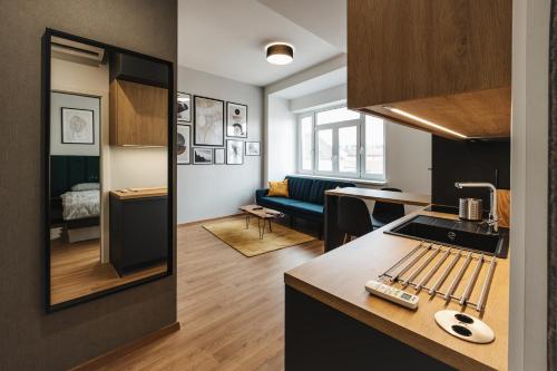 a kitchen and a living room with a couch at Apartment FRIENDs Bratislava in Bratislava