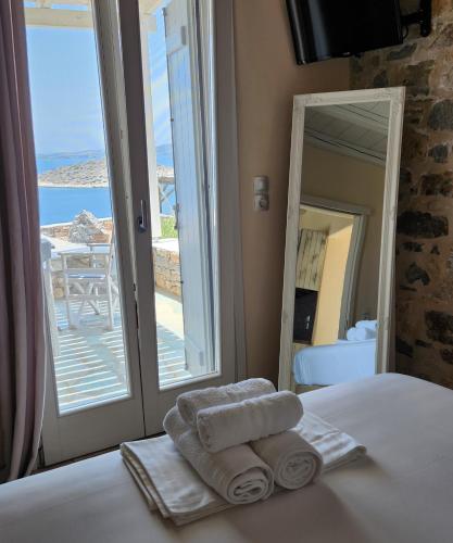 a bedroom with a bed with towels and a window at Villa Panorama in Irakleia