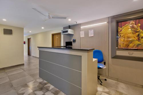 an office with a reception desk and a blue chair at Blessings Residency in Rājpur