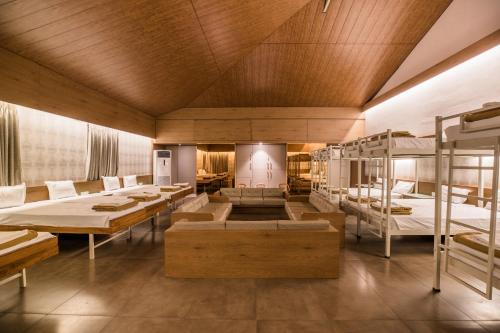 a room with bunk beds and tables and benches at Urmilaa Green County Resort 35 KM From Kolhapur in Kolhapur