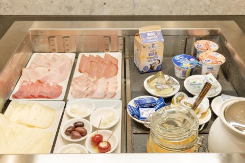 a drawer filled with different types of meats and cheese at Hotel Garni Jagdhof in Zell am Ziller