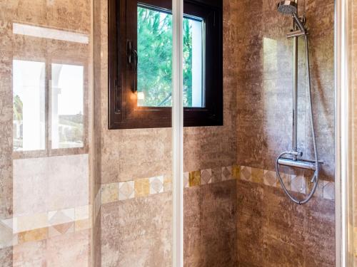 a shower with a glass door in a bathroom at REf 4 CASA BLANCA in Zahara de los Atunes