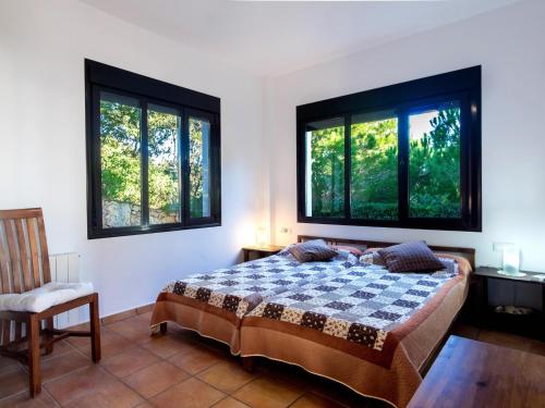 a bedroom with a bed and two windows at REf 4 CASA BLANCA in Zahara de los Atunes