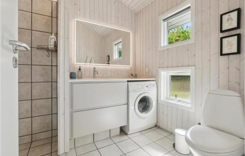 a white laundry room with a washer and dryer at Lovely Home In Allinge With Wifi in Allinge