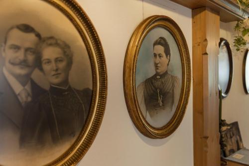 two framed portraits of two men on a wall at Hotel Garni Jagdhof in Zell am Ziller