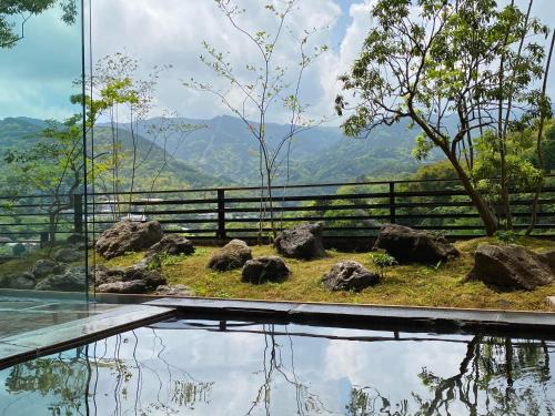 a glass house with a view of the mountains at Kaiseki Ryokan Ashikari in Yugawara