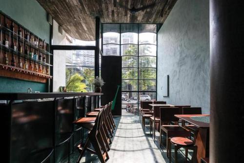 a restaurant with tables and chairs and a large window at The Memory - Danang in Da Nang