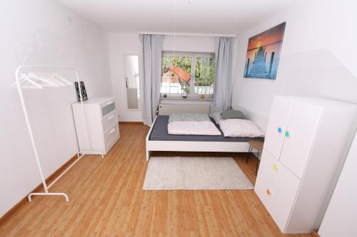 a bedroom with a bed and a window at Moderne, herzliche und große Ferienwohnung mitten im Naturpark in Grebenhain