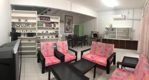 a room with chairs and a table in a store at R & R in Tawau