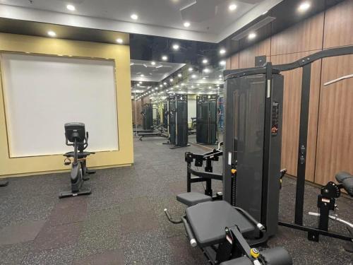 a gym with several tread machines and a white board at Apartment 1BR-FL25th-R103 Building-Vinhomes Ocean Park in Hanoi