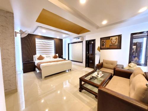 sala de estar amplia con cama y sofá en Hotel The Daanish Residency, en Nueva Delhi