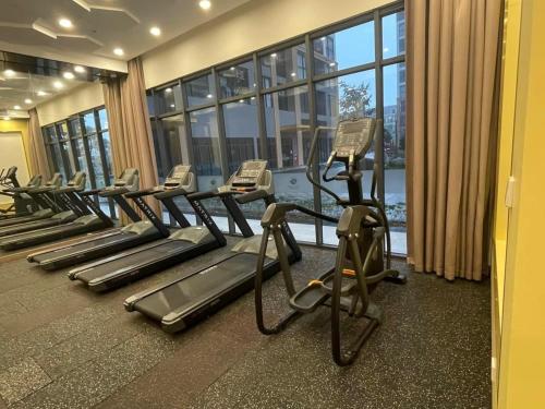 a gym with rows of tread machines in a building at Apartment 1BR-FL25th-R103 Building-Vinhomes Ocean Park in Hanoi