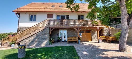 a house with a deck and a patio at Tó apartman in Tihany