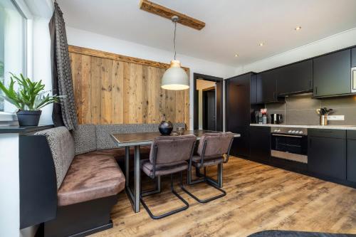 a kitchen and dining room with a table and chairs at Landhaus Rustika in Wagrain