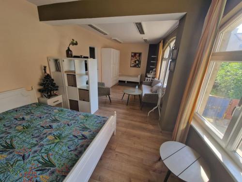 a bedroom with a bed and a living room at La Maison Ruse Apartments in Ruse