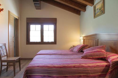 Un dormitorio con una cama grande y una ventana en Casa Rural Sarobetxea en Larrayoz, Navarra, 