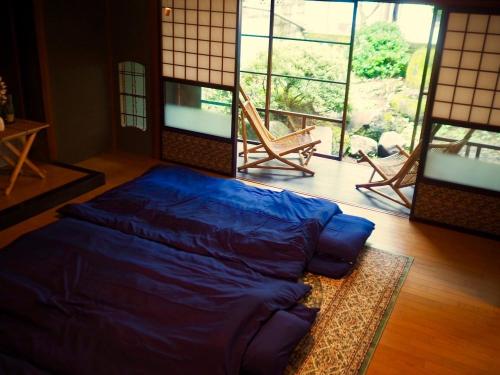 茅野市にあるfumoku - Vacation STAY 04226vの大きな窓付きの客室の青いベッド1台分です。