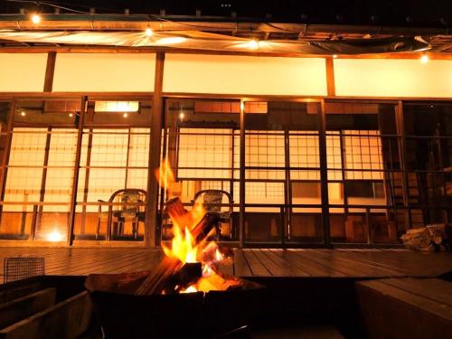 a fire pit in a large room with windows at fumoku - Vacation STAY 04226v in Chino