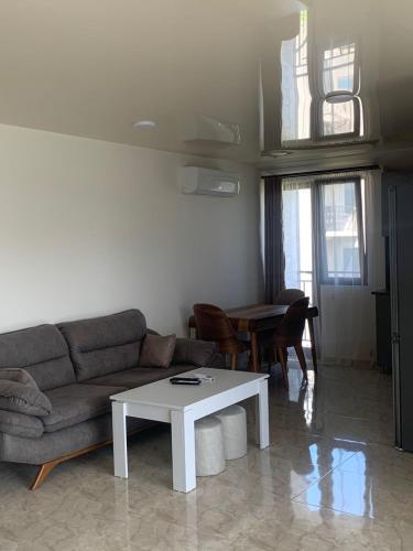 a living room with a couch and a table at Guest House OASI in Batumi