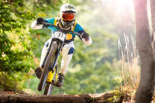 a person on a dirt bike jumping over a log at Apartmán Kubínska 33 in Dolný Kubín