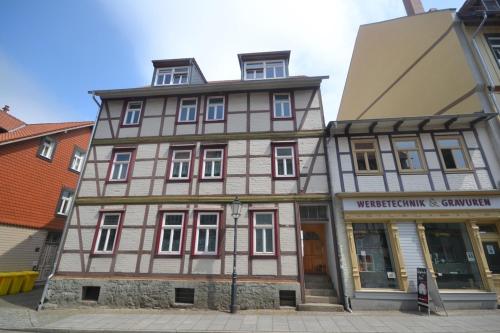 a large wooden building on the corner of a street at Bertel 1 in Wernigerode