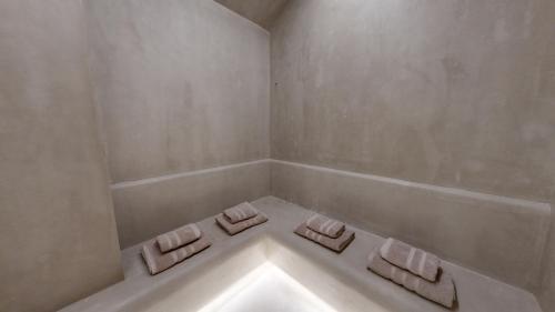 a white bathroom with two towels on a tub at Acrotel Athena Residence in Elia