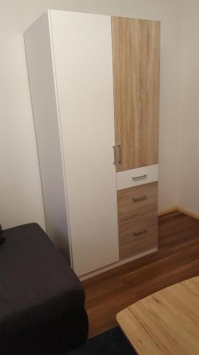 a bedroom with a white closet and a wooden cabinet at Bertel 1 in Wernigerode