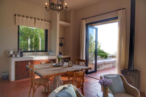 a kitchen and dining room with a table and a fireplace at Bkerzay in Baakleen