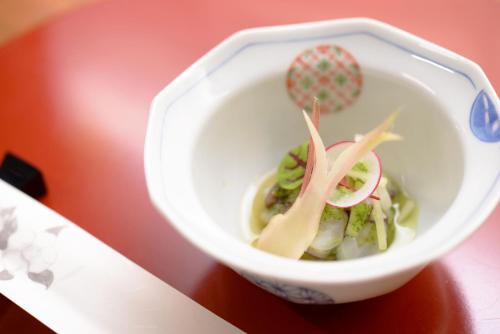 a white bowl of food on a table at Kaiseki Ryokan Ashikari in Yugawara
