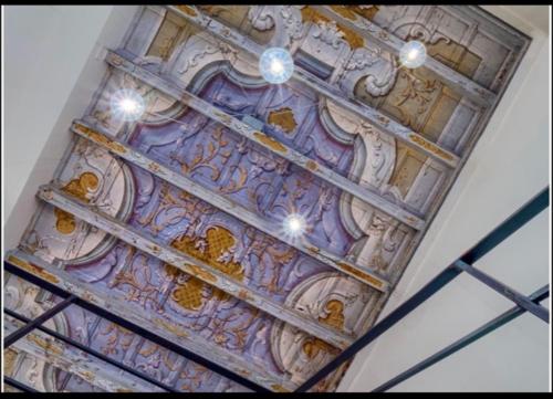 a ceiling of a building with paintings on it at VILLA VINICIA, pool, jacuzzi, airco in Domaso