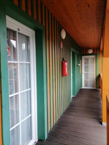 a hallway of a building with green and colorful walls at Pension Bomätscher in Königstein an der Elbe