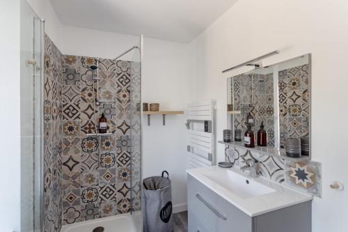 e bagno con servizi igienici, lavandino e doccia. di La Maison de Louise - Superbe maison avec patio a Cancale