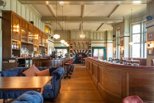 a restaurant with couches and a bar at Cliftonville Hotel in Cromer