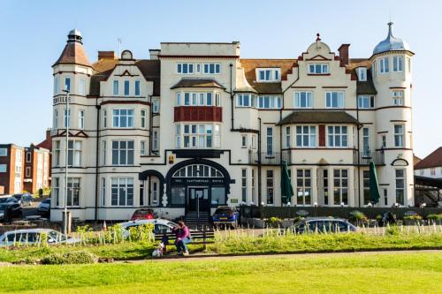a large building with people walking in front of it at Cliftonville Hotel in Cromer