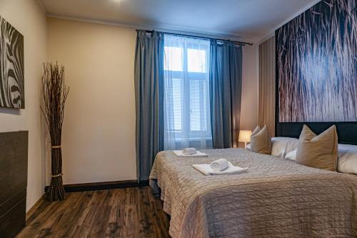 a hotel room with a bed with towels on it at STING Boutique Apartments in Ostrava