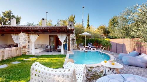 a backyard with a swimming pool and a house at Acrotel Athena Residence in Elia
