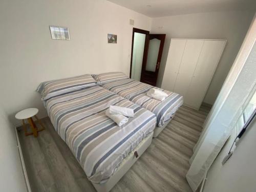 a bedroom with two beds with towels on them at Casa Raquelina in Gijón