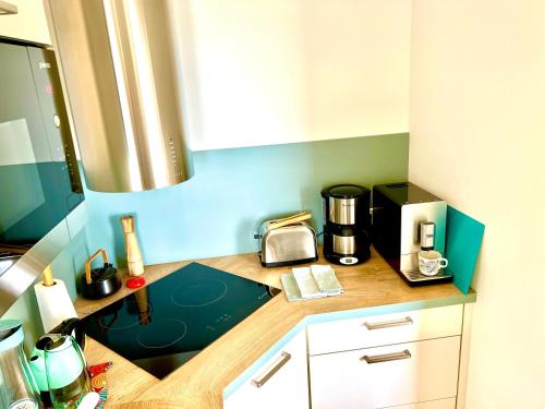 a kitchen with a counter with a coffee maker on it at Glaz Ocean in Douarnenez