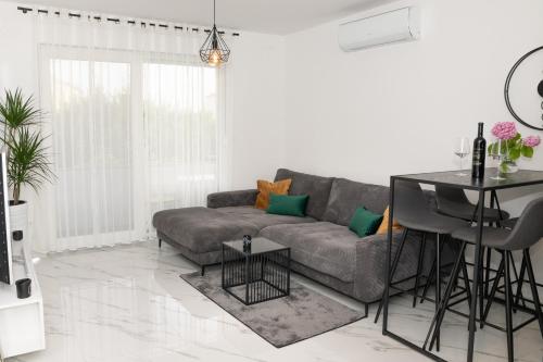 a living room with a couch and a table at Apartment Adam in Zadar