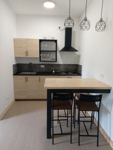 a kitchen with a table and chairs and a tv at CASALIDIA monolocale in Valli del Pasubio