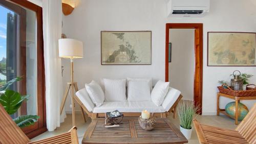 a living room with a white couch and a table at La Maranita Apartment in La Maddalena