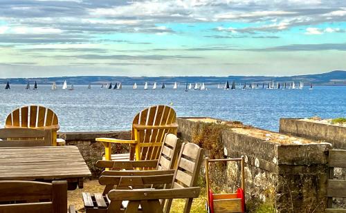two chairs and a table and a view of the water at Glaz Ocean in Douarnenez
