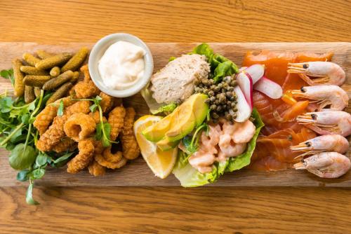 a plate of food with a sandwich and other foods at Cliftonville Hotel in Cromer
