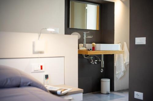 a bathroom with a sink and a mirror at Le vie del Borgo in Civita