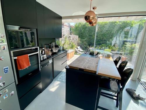 uma cozinha com uma mesa e uma grande janela em Proche Paris et Disney, maison avec piscine sauna em Sucy-en-Brie