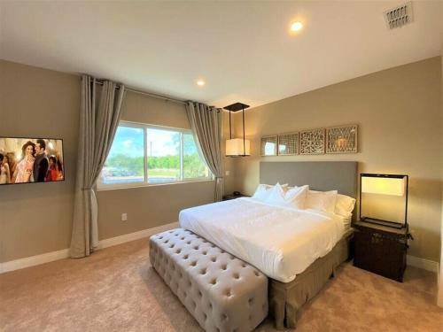a bedroom with a large bed and a window at Private Hot Tub BBQ Grill at Magic Village Views in Orlando