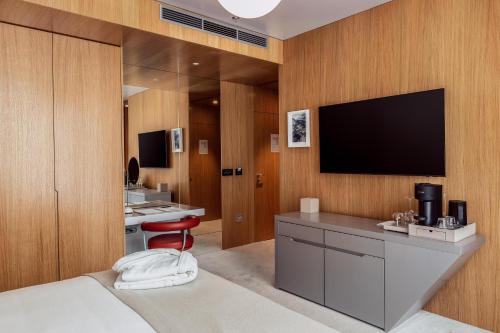 a hotel room with a flat screen tv on the wall at Met Boutique Hotel in Zagreb